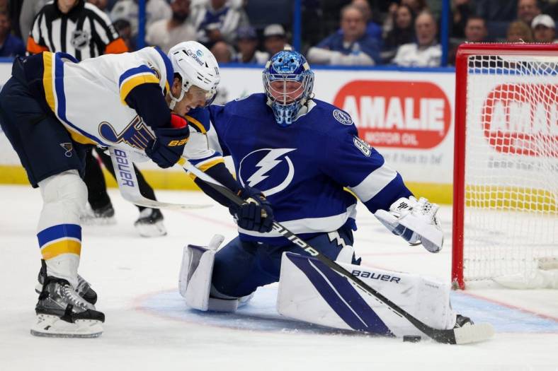 Nov 25, 2022; Tampa, Florida, USA;  Tampa Bay Lightning goaltender Andrei Vasilevskiy (88) makes a save on St. Louis Blues center Brayden Schenn (10) in the second period at Amalie Arena. Mandatory Credit: Nathan Ray Seebeck-USA TODAY Sports