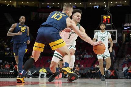 Nov 25, 2022; Portland, Oregon, USA;  West Virginia Mountaineers guard Erik Stevenson (10) steals the basketball away from Portland State Vikings guard Cameron Parker (1) during the first half at Moda Center. Mandatory Credit: Troy Wayrynen-USA TODAY Sports