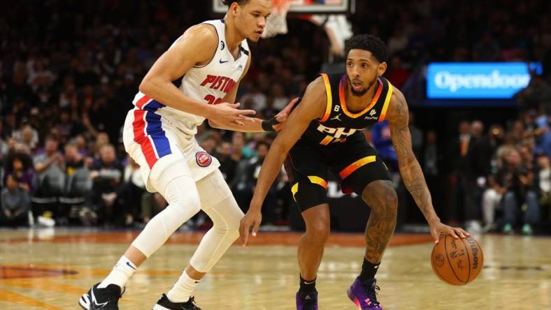 Nov 25, 2022; Phoenix, Arizona, USA; Phoenix Suns guard Cameron Payne (15) moves the ball against Detroit Pistons forward Kevin Knox II in the first half at Footprint Center. Mandatory Credit: Mark J. Rebilas-USA TODAY Sports