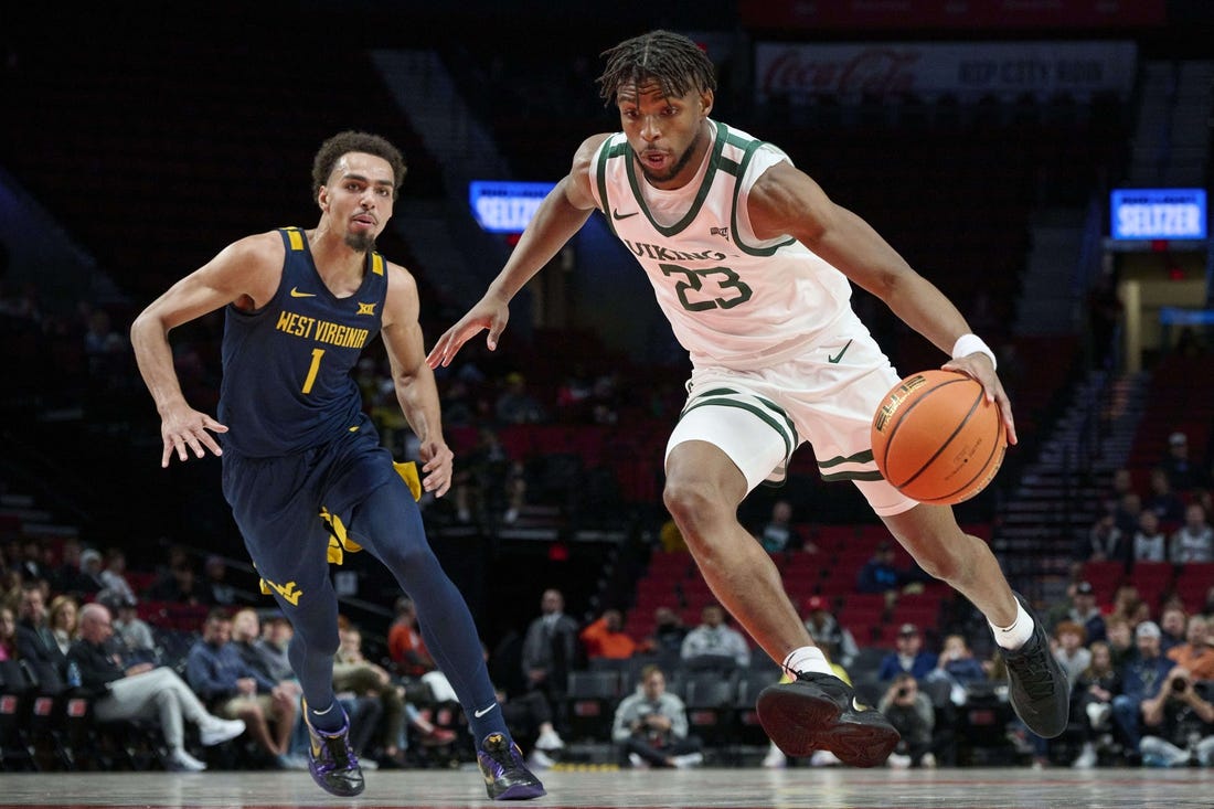 Nov 25, 2022; Portland, Oregon, USA; Portland State Vikings guard Jorell Saterfield (23) drives to the basket past West Virginia Mountaineers forward Emmitt Matthews Jr. (1) during the first half at Moda Center. Mandatory Credit: Troy Wayrynen-USA TODAY Sports