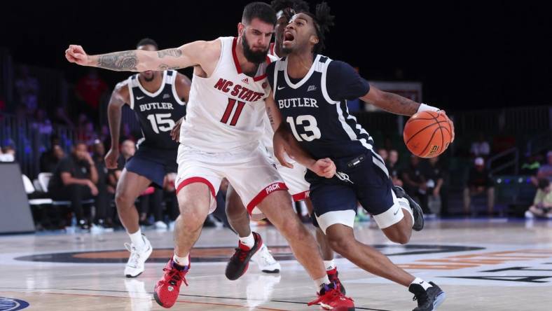 Nov 25, 2022; Paradise Island, BAHAMAS; Butler Bulldogs guard Jayden Taylor (13) drives to the basket as North Carolina State Wolfpack forward Dusan Mahorcic (11) defends during the second half at Imperial Arena. Mandatory Credit: Kevin Jairaj-USA TODAY Sports