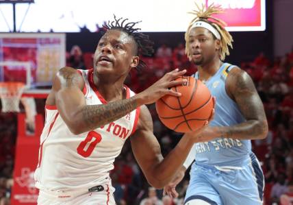 Nov 26, 2022; Houston, Texas, USA; Houston Cougars guard Marcus Sasser (0) drives to the net as Kent State Golden Flashes forward VonCameron Davis (1) chases in the first half at the Fertitta Center. Mandatory Credit: Thomas Shea-USA TODAY Sports