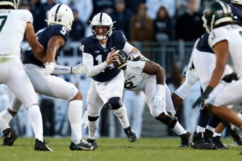 Nov 26, 2022; University Park, Pennsylvania, USA; Penn State Nittany Lions quarterback Sean Clifford (14) runs with the ball during the first quarter against the Michigan State Spartans at Beaver Stadium. Mandatory Credit: Matthew OHaren-USA TODAY Sports