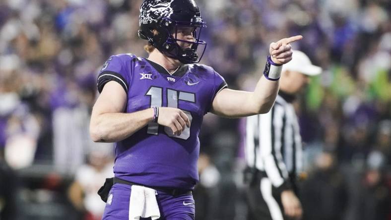 Nov 26, 2022; Fort Worth, Texas, USA; TCU Horned Frogs quarterback Max Duggan (15) points at his receiver after thrown a touchdown pass against the Iowa State Cyclones during second half at Amon G. Carter Stadium. Mandatory Credit: Raymond Carlin III-USA TODAY Sports