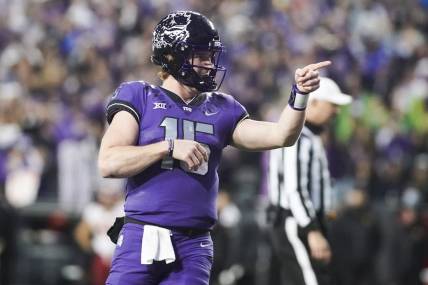 Nov 26, 2022; Fort Worth, Texas, USA; TCU Horned Frogs quarterback Max Duggan (15) points at his receiver after thrown a touchdown pass against the Iowa State Cyclones during second half at Amon G. Carter Stadium. Mandatory Credit: Raymond Carlin III-USA TODAY Sports