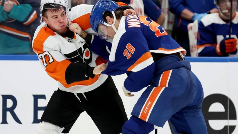 Nov 26, 2022; Elmont, New York, USA; Philadelphia Flyers defenseman Tony DeAngelo (77) fights New York Islanders right wing Oliver Wahlstrom (26) during the third period at UBS Arena. Mandatory Credit: Brad Penner-USA TODAY Sports