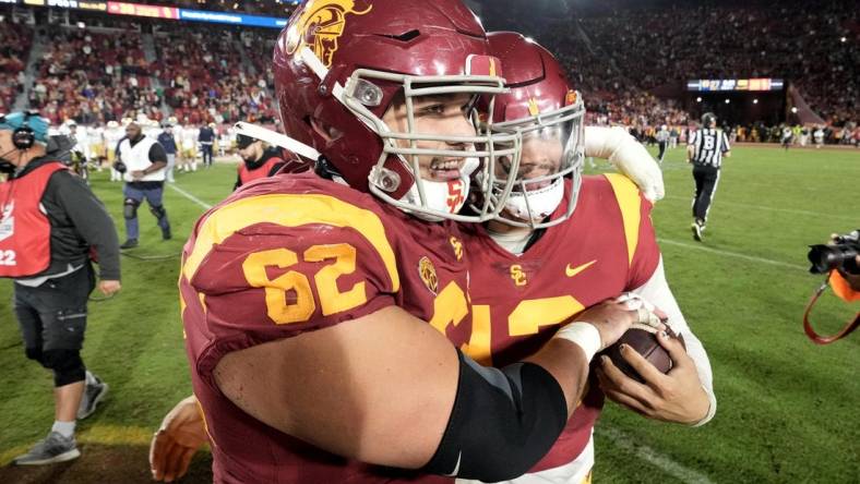 Nov 26, 2022; Los Angeles, California, USA; Southern California Trojans quarterback Caleb Williams (13) and offensive lineman Brett Neilon (62) celebrate after the game against the Notre Dame Fighting Irish at United Airlines Field at Los Angeles Memorial Coliseum. Mandatory Credit: Kirby Lee-USA TODAY Sports