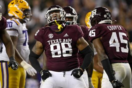 Nov 26, 2022; College Station, Texas, USA; Texas A&M Aggies defensive lineman Walter Nolen (88) and linebacker Edgerrin Cooper (45) celebrate a defensive stop against the LSU Tigers during the second half at Kyle Field. Mandatory Credit: Jerome Miron-USA TODAY Sports