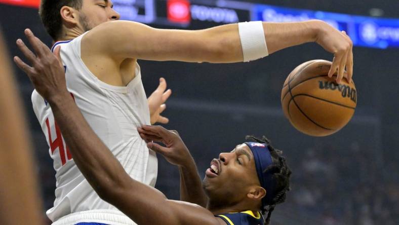 Nov 27, 2022; Los Angeles, California, USA;  Los Angeles Clippers center Ivica Zubac (40) blocks a shot by Indiana Pacers guard Buddy Hield (24) in the first half at Crypto.com Arena. Mandatory Credit: Jayne Kamin-Oncea-USA TODAY Sports