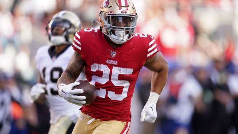 Nov 27, 2022; Santa Clara, California, USA; San Francisco 49ers running back Elijah Mitchell (25) runs the ball against the New Orleans Saints in the second quarter at Levi's Stadium. Mandatory Credit: Cary Edmondson-USA TODAY Sports