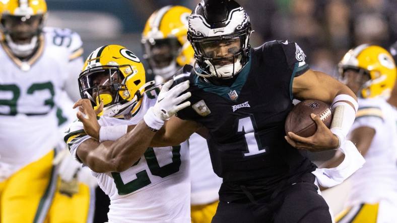 Nov 27, 2022; Philadelphia, Pennsylvania, USA; Philadelphia Eagles quarterback Jalen Hurts (1) runs with the ball against Green Bay Packers safety Rudy Ford (20) during the second quarter at Lincoln Financial Field. Mandatory Credit: Bill Streicher-USA TODAY Sports