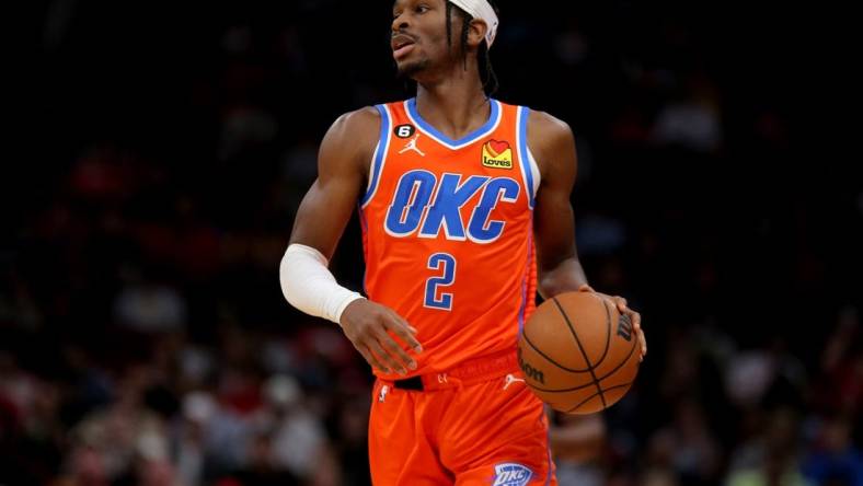 Nov 26, 2022; Houston, Texas, USA; Oklahoma City Thunder guard Shai Gilgeous-Alexander (2) handles the ball against the Houston Rockets during the game at Toyota Center. Mandatory Credit: Erik Williams-USA TODAY Sports