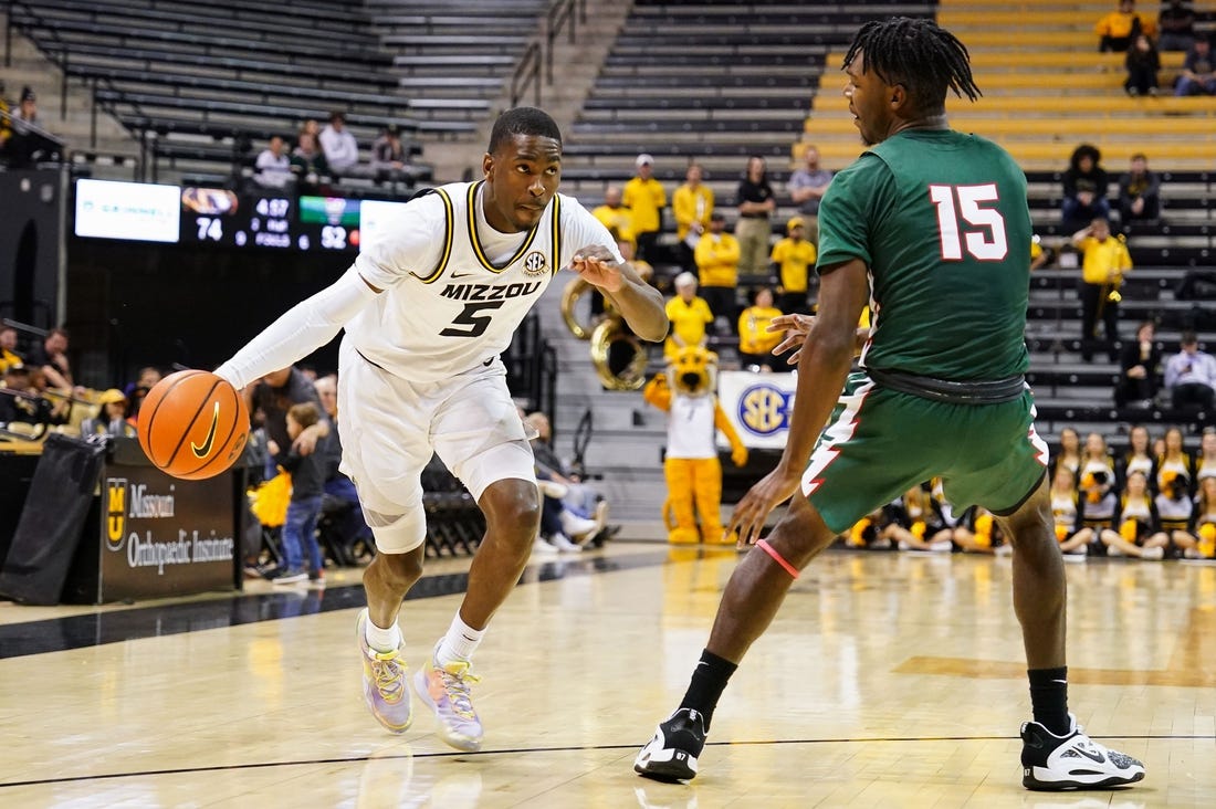 Nov 20, 2022; Columbia, Missouri, USA; Missouri Tigers guard D'Moi Hodge (5) drives against Mississippi Valley State Delta Devils forward Alvin Stredic (15) during the second half at Mizzou Arena. Mandatory Credit: Jay Biggerstaff-USA TODAY Sports