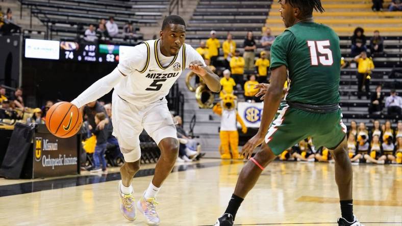 Nov 20, 2022; Columbia, Missouri, USA; Missouri Tigers guard D'Moi Hodge (5) drives against Mississippi Valley State Delta Devils forward Alvin Stredic (15) during the second half at Mizzou Arena. Mandatory Credit: Jay Biggerstaff-USA TODAY Sports