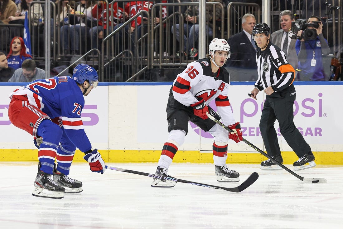 Nov 28, 2022; New York, New York, USA; New Jersey Devils center Jack Hughes (86) carries the puck in front of New York Rangers center Filip Chytil (72) during the first period at Madison Square Garden. Mandatory Credit: Vincent Carchietta-USA TODAY Sports