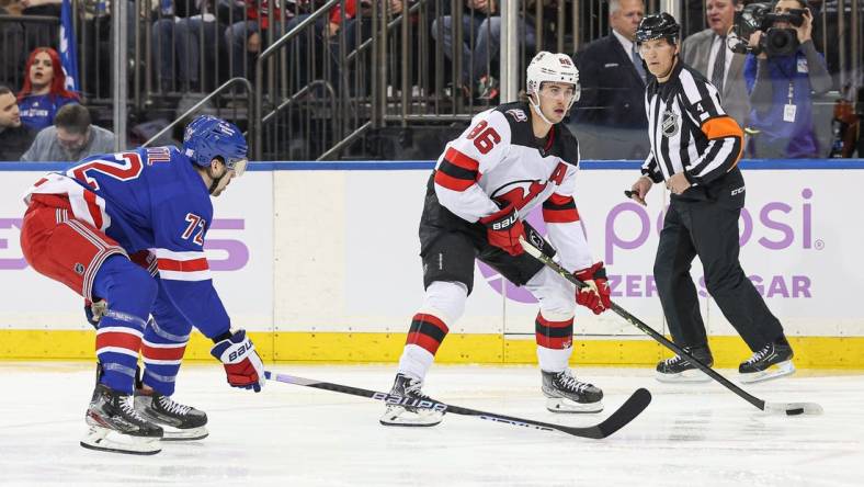 Nov 28, 2022; New York, New York, USA; New Jersey Devils center Jack Hughes (86) carries the puck in front of New York Rangers center Filip Chytil (72) during the first period at Madison Square Garden. Mandatory Credit: Vincent Carchietta-USA TODAY Sports