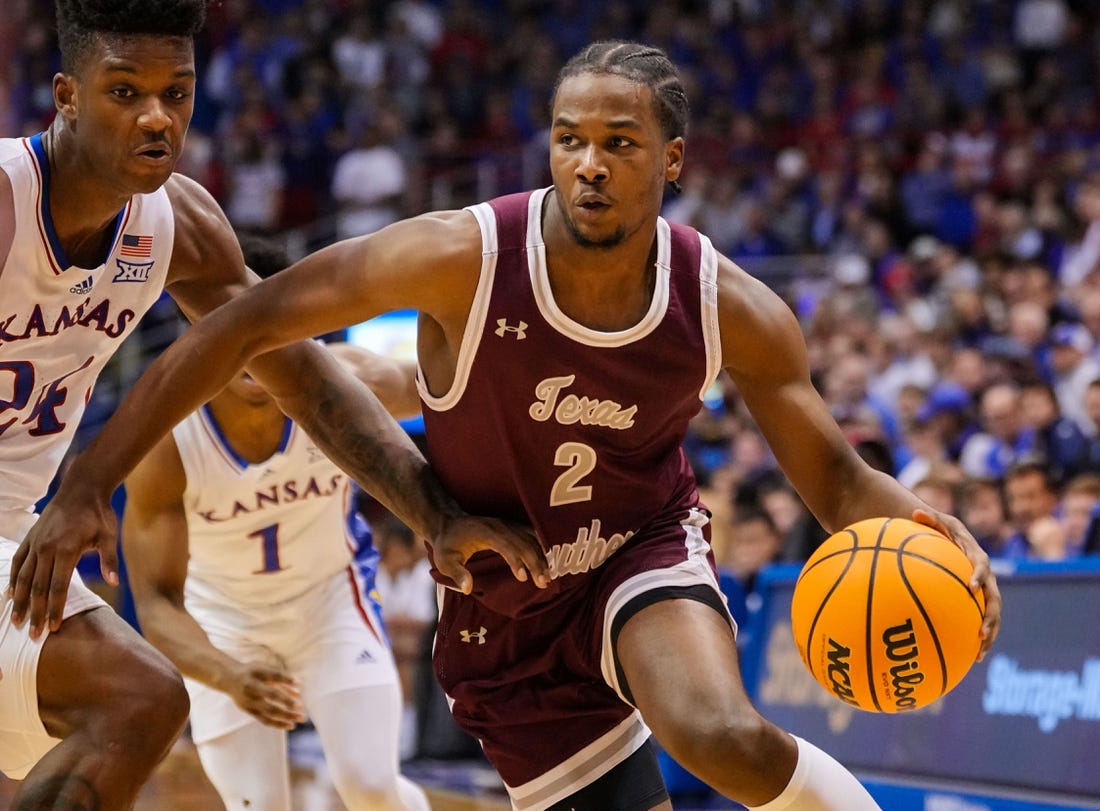 Nov 28, 2022; Lawrence, Kansas, USA; Texas Southern Tigers forward Davon Barnes (2) drives against Kansas Jayhawks forward K.J. Adams Jr. (24) during the first half at Allen Fieldhouse. Mandatory Credit: Jay Biggerstaff-USA TODAY Sports