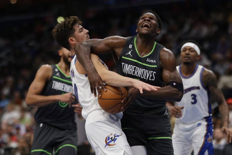 Nov 28, 2022; Washington, District of Columbia, USA; Minnesota Timberwolves guard Anthony Edwards (1) is fouled by Washington Wizards forward Deni Avdija (9) in the second quarter at Capital One Arena. Mandatory Credit: Geoff Burke-USA TODAY Sports