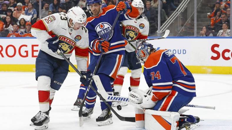 Nov 28, 2022; Edmonton, Alberta, CAN; Edmonton Oilers goaltender Stuart Skinner (74) makes a save on a deflection by Florida Panthers forward Carter Verhaeghe (23) during the second period at Rogers Place. Mandatory Credit: Perry Nelson-USA TODAY Sports