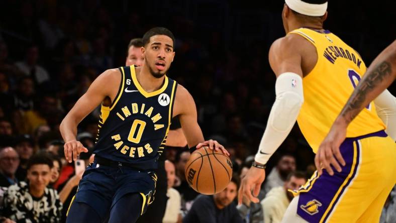 Nov 28, 2022; Los Angeles, California, USA; Indiana Pacers guard Tyrese Haliburton (0) controls the ball against Los Angeles Lakers guard Russell Westbrook (0) in the first half at Crypto.com Arena. Mandatory Credit: Richard Mackson-USA TODAY Sports