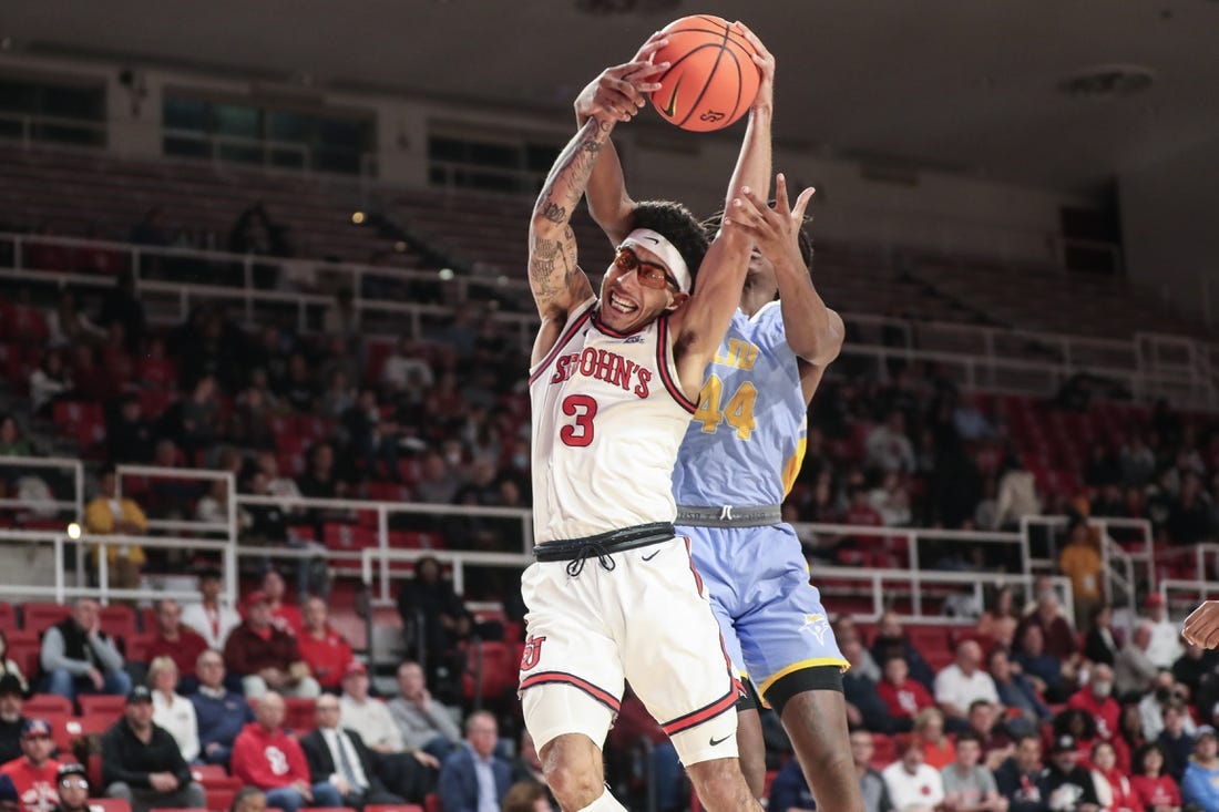 Nov 29, 2022; Queens, New York, USA;  St. John's Red Storm guard Andre Curbelo (3) and Long Island University guard Quion Burns (44) fight for a rebound in the first half at Carnesecca Arena. Mandatory Credit: Wendell Cruz-USA TODAY Sports