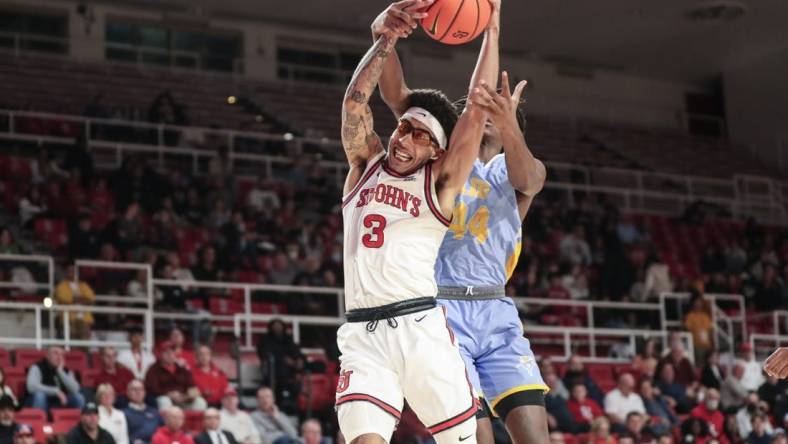 Nov 29, 2022; Queens, New York, USA;  St. John's Red Storm guard Andre Curbelo (3) and Long Island University guard Quion Burns (44) fight for a rebound in the first half at Carnesecca Arena. Mandatory Credit: Wendell Cruz-USA TODAY Sports