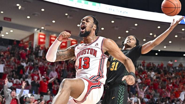 Nov 29, 2022; Houston, Texas, USA; Houston Cougars forward J'Wan Roberts (13) reacts after a dunk against the Norfolk State Spartans during the first half at Fertitta Center. Mandatory Credit: Maria Lysaker-USA TODAY Sports