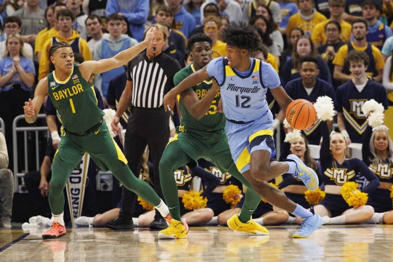 Nov 29, 2022; Milwaukee, Wisconsin, USA;  Marquette Golden Eagles forward Olivier-Maxence Prosper (12) drives fore the basket against Baylor Bears forward Josh Ojianwuna (15) during the first half at Fiserv Forum. Mandatory Credit: Jeff Hanisch-USA TODAY Sports