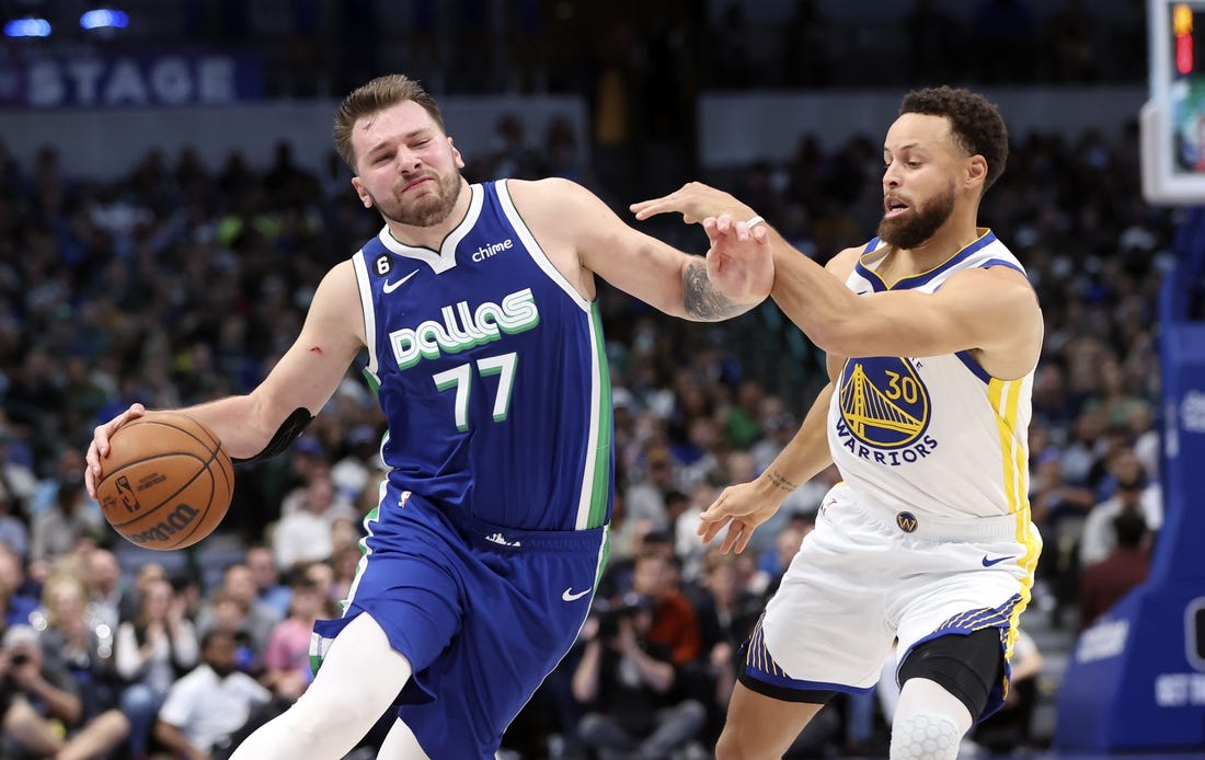 Nov 29, 2022; Dallas, Texas, USA;  Dallas Mavericks guard Luka Doncic (77) controls the ball as Golden State Warriors guard Stephen Curry (30) defends during the second half at American Airlines Center. Mandatory Credit: Kevin Jairaj-USA TODAY Sports