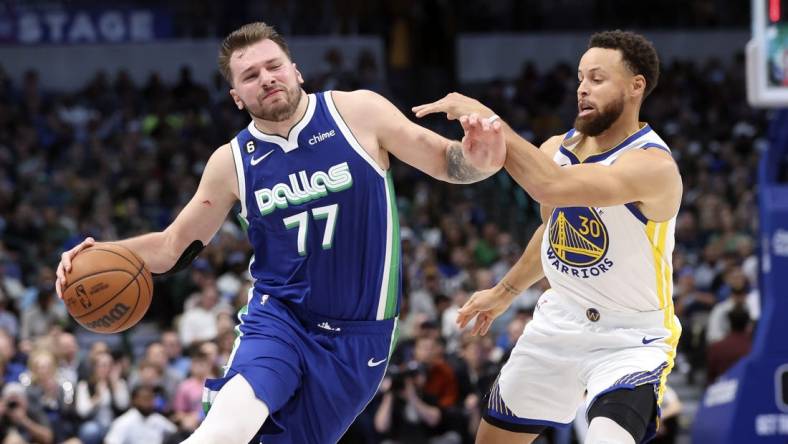 Nov 29, 2022; Dallas, Texas, USA;  Dallas Mavericks guard Luka Doncic (77) controls the ball as Golden State Warriors guard Stephen Curry (30) defends during the second half at American Airlines Center. Mandatory Credit: Kevin Jairaj-USA TODAY Sports