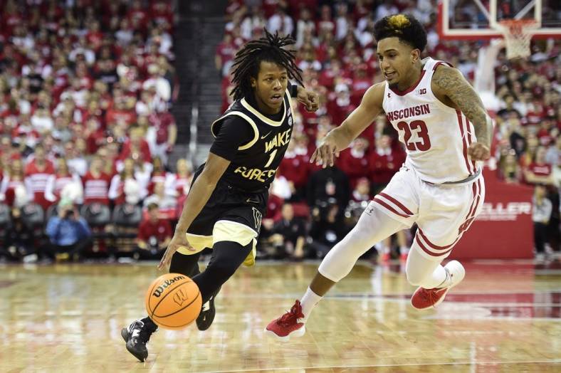 Nov 29, 2022; Madison, Wisconsin, USA;  Wake Forest Demon Deacons guard Tyree Appleby (1) drives to the basket under coverage by Wisconsin Badgers guard Chucky Hepburn (23) during the first half at the Kohl Center. Mandatory Credit: Kayla Wolf-USA TODAY Sports