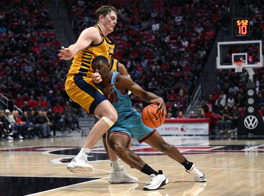 Nov 29, 2022; San Diego, California, USA; San Diego State Aztecs guard Lamont Butler (5) collides with UC Irvine Anteaters forward Dean Keeler (31) during the first half at Viejas Arena. Mandatory Credit: Orlando Ramirez-USA TODAY Sports