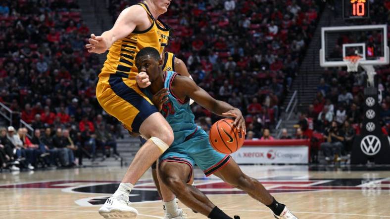 Nov 29, 2022; San Diego, California, USA; San Diego State Aztecs guard Lamont Butler (5) collides with UC Irvine Anteaters forward Dean Keeler (31) during the first half at Viejas Arena. Mandatory Credit: Orlando Ramirez-USA TODAY Sports