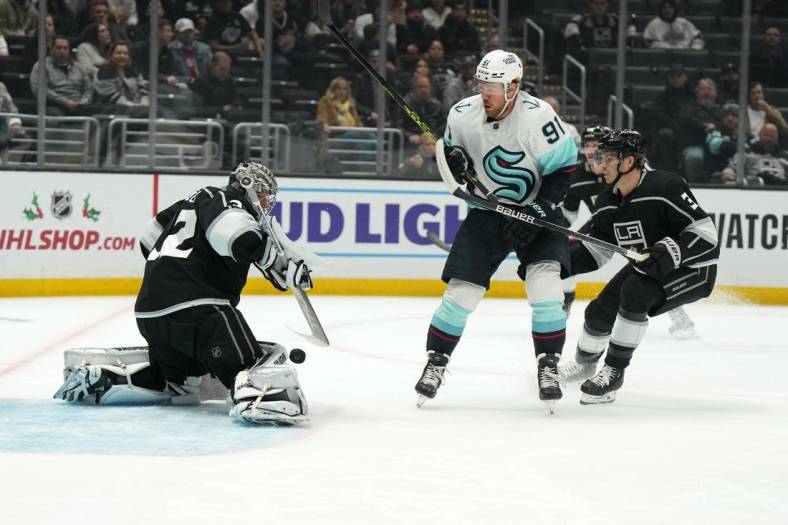 Nov 29, 2022; Los Angeles, California, USA; LA Kings goaltender Jonathan Quick (32) and defenseman Matt Roy (3) defend the goal against Seattle Kraken right wing Daniel Sprong (91) in the first period at Crypto.com Arena. Mandatory Credit: Kirby Lee-USA TODAY Sports