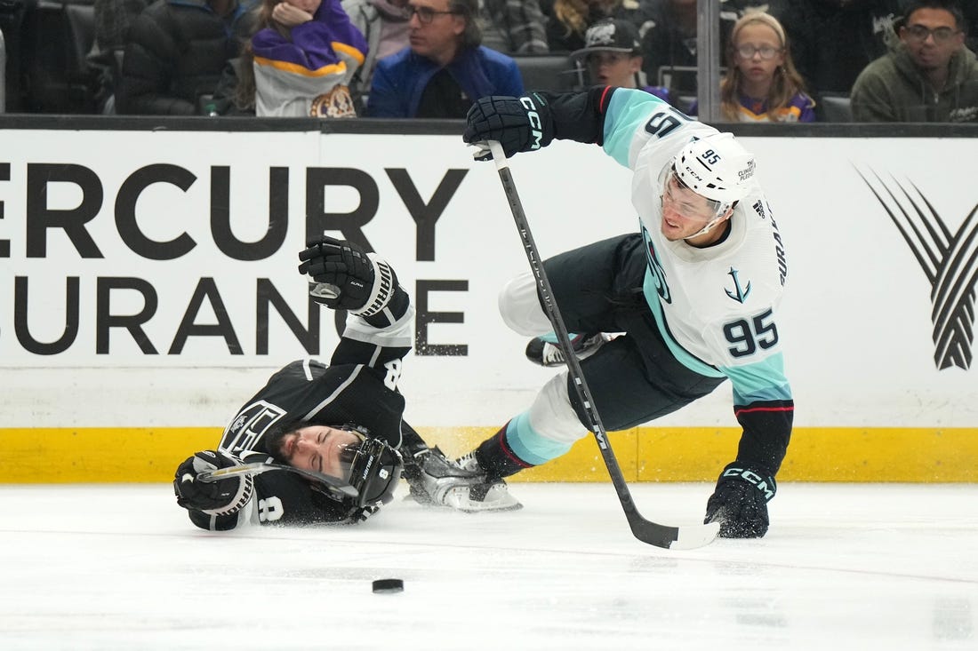 Nov 29, 2022; Los Angeles, California, USA; Seattle Kraken left wing Andre Burakovsky (95) collides with LA Kings defenseman Drew Doughty (8) in the third period at Crypto.com Arena. Mandatory Credit: Kirby Lee-USA TODAY Sports