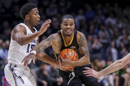 Nov 30, 2022; Cincinnati, Ohio, USA; Southeastern Louisiana Lions guard Christian Agnew (24) moves to the basket against Xavier Musketeers guard KyKy Tandy (15) in the first half at Cintas Center. Mandatory Credit: Katie Stratman-USA TODAY Sports