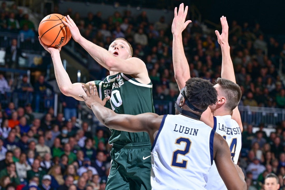 Nov 30, 2022; South Bend, Indiana, USA; Michigan State Spartans forward Joey Hauser (10) goes up for a shot as Notre Dame Fighting Irish forward Ven-Allen Lubin (2) and forward Nate Laszewski (14) defend in the first half at the Purcell Pavilion. Mandatory Credit: Matt Cashore-USA TODAY Sports