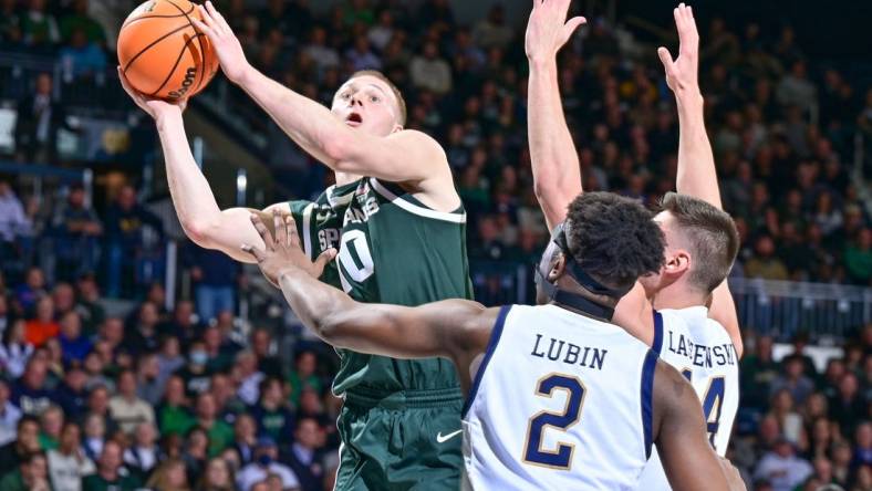 Nov 30, 2022; South Bend, Indiana, USA; Michigan State Spartans forward Joey Hauser (10) goes up for a shot as Notre Dame Fighting Irish forward Ven-Allen Lubin (2) and forward Nate Laszewski (14) defend in the first half at the Purcell Pavilion. Mandatory Credit: Matt Cashore-USA TODAY Sports