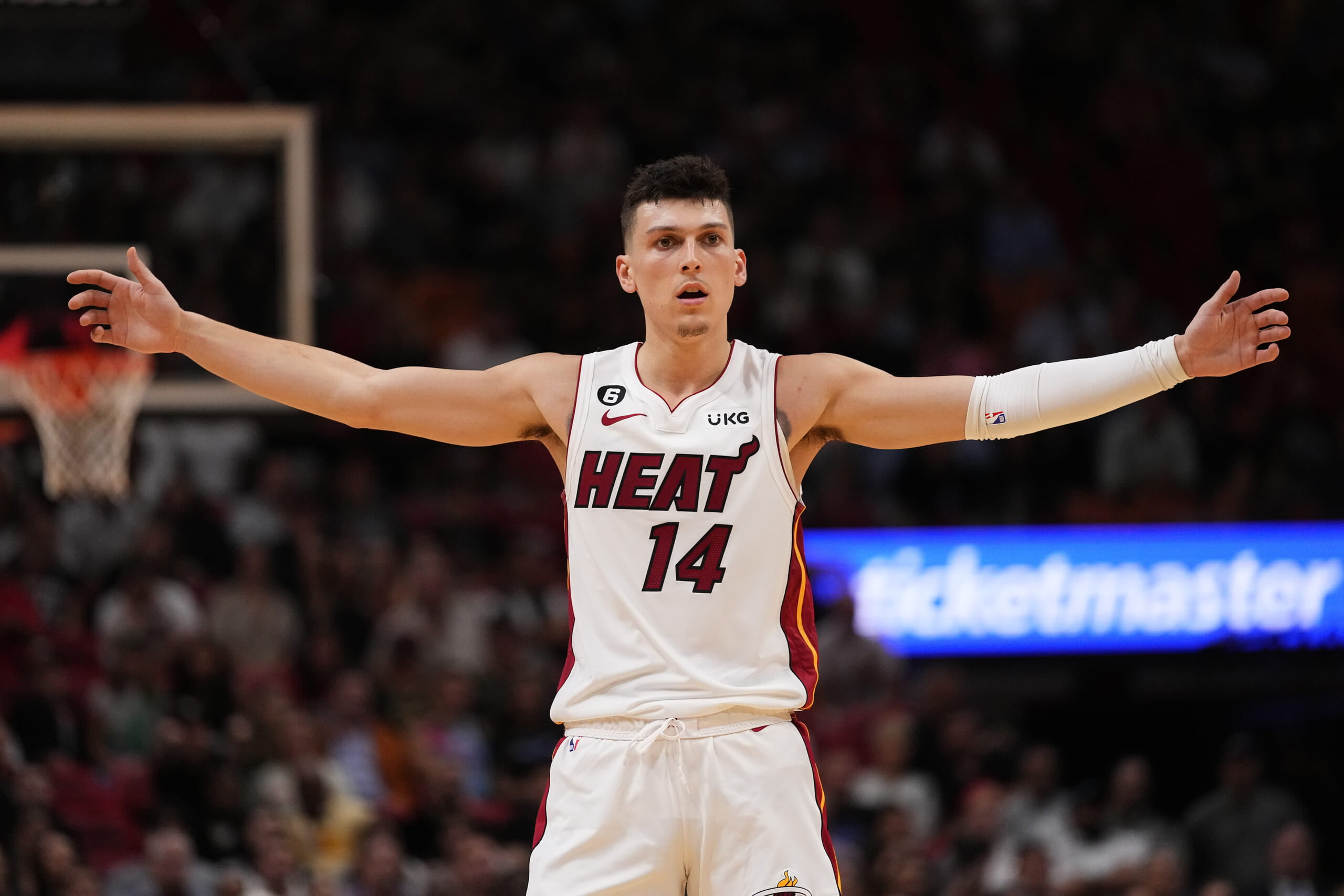 Tyler Herro wears beach outfit on bench during Game 5