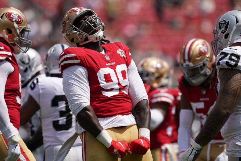 Aug 29, 2021; Santa Clara, California, USA; San Francisco 49ers defensive tackle Javon Kinlaw (99) reacts after making a tackle against the Las Vegas Raiders in the first quarter at Levi's Stadium. Mandatory Credit: Cary Edmondson-USA TODAY Sports