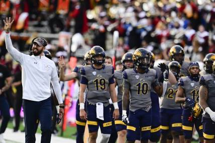 Sep 25, 2021; College Park, Maryland, USA;  Kent State Golden Flashes head coach Sean Lewis walks with players at the beginning of the fourth quarter against the Maryland Terrapins at Capital One Field at Maryland Stadium. Mandatory Credit: Tommy Gilligan-USA TODAY Sports