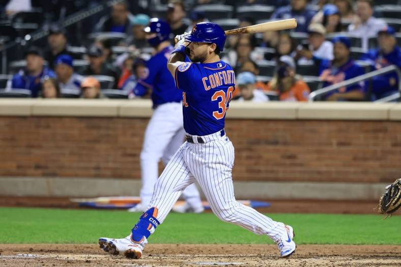 Sep 30, 2021; New York City, New York, USA; New York Mets right fielder Michael Conforto (30) hits an RBI single during the third inning against the Miami Marlins at Citi Field. Mandatory Credit: Vincent Carchietta-USA TODAY Sports
