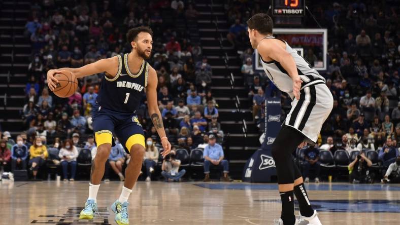 Dec 31, 2021; Memphis, Tennessee, USA; Memphis Grizzlies guard Tyrell Terry (1) controls the ball against San Antonio Spurs forward Doug McDermott (right) during the second half at FedExForum. Mandatory Credit: Justin Ford-USA TODAY Sports