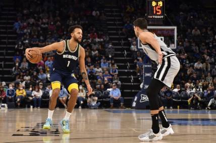 Dec 31, 2021; Memphis, Tennessee, USA; Memphis Grizzlies guard Tyrell Terry (1) controls the ball against San Antonio Spurs forward Doug McDermott (right) during the second half at FedExForum. Mandatory Credit: Justin Ford-USA TODAY Sports