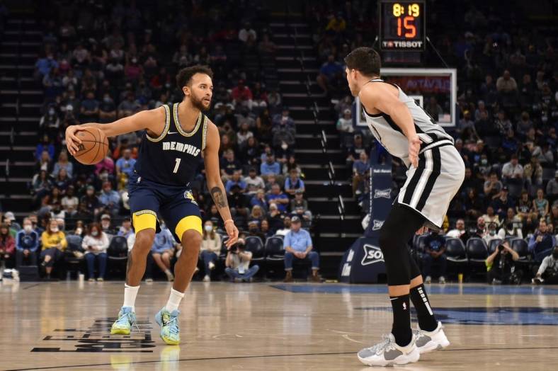 Dec 31, 2021; Memphis, Tennessee, USA; Memphis Grizzlies guard Tyrell Terry (1) controls the ball against San Antonio Spurs forward Doug McDermott (right) during the second half at FedExForum. Mandatory Credit: Justin Ford-USA TODAY Sports