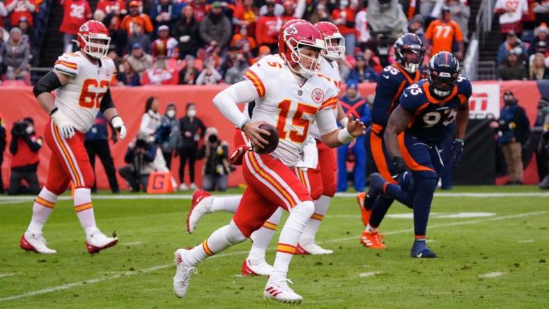 Jan 8, 2022; Denver, Colorado, USA; Kansas City Chiefs quarterback Patrick Mahomes (15) runs the ball in the first quarter against the Denver Broncos at Empower Field at Mile High. Mandatory Credit: Ron Chenoy-USA TODAY Sports