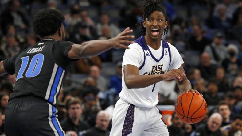 Jan 27, 2022; Memphis, Tennessee, USA; East Carolina Pirates guard Javon Small (1) dribbles as Memphis Tigers guard Alex Lomax (10) defends during the second half at FedExForum. Mandatory Credit: Petre Thomas-USA TODAY Sports