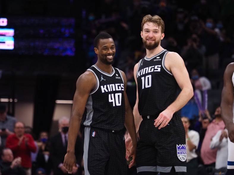Feb 9, 2022; Sacramento, California, USA; Sacramento Kings forward Harrison Barnes (40) and center Domantas Sabonis (10) smiles in the final seconds of the game against the Minnesota Timberwolves during the fourth quarter at Golden 1 Center. Mandatory Credit: Kelley L Cox-USA TODAY Sports