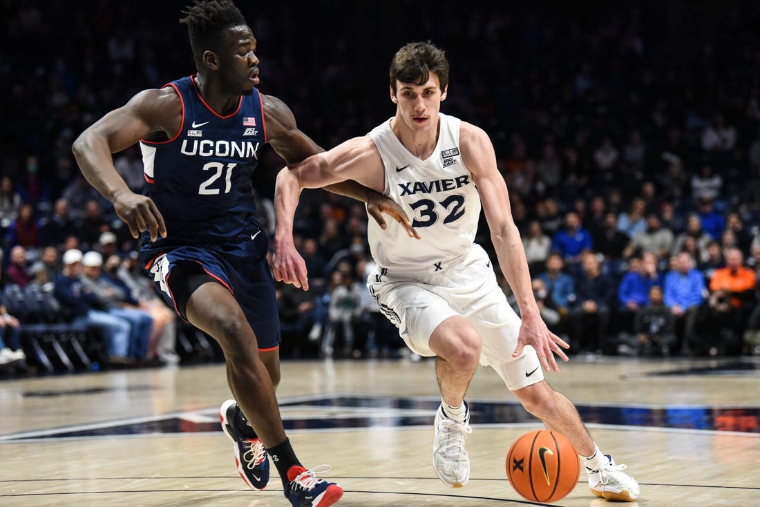 Xavier's Zach Freemantle takes the ball down the court during the game between Xavier and Uconn at Cintas Center on Friday February 11, 2022. Xavier lead the game at halftime with a score of 34-31.