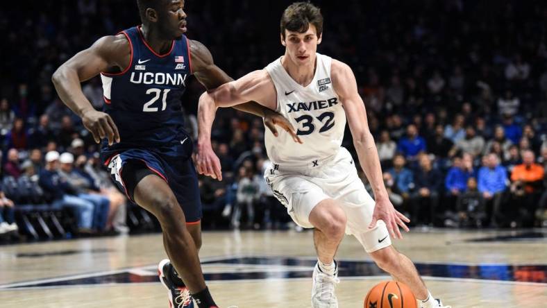 Xavier's Zach Freemantle takes the ball down the court during the game between Xavier and Uconn at Cintas Center on Friday February 11, 2022. Xavier lead the game at halftime with a score of 34-31.